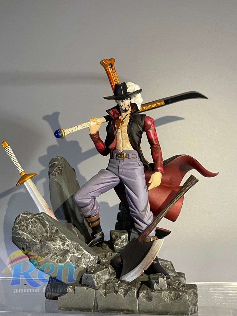 Scultures: Dracule Mihawk (Category: Figurines & Statues) located in Calasiao. Submitted by grandshark_635287 (Listing ID 1467295140, Image 1). Description: - Character: Dracule Mihawk from One Piece - Design: Wears red cape, purple trousers, and open vest, standing on a detailed rocky base - Weapons: Includes his signature black blade Yoru and extra swords stuck in the ground around the base - Condition: Loose item, no box included - Perfect for