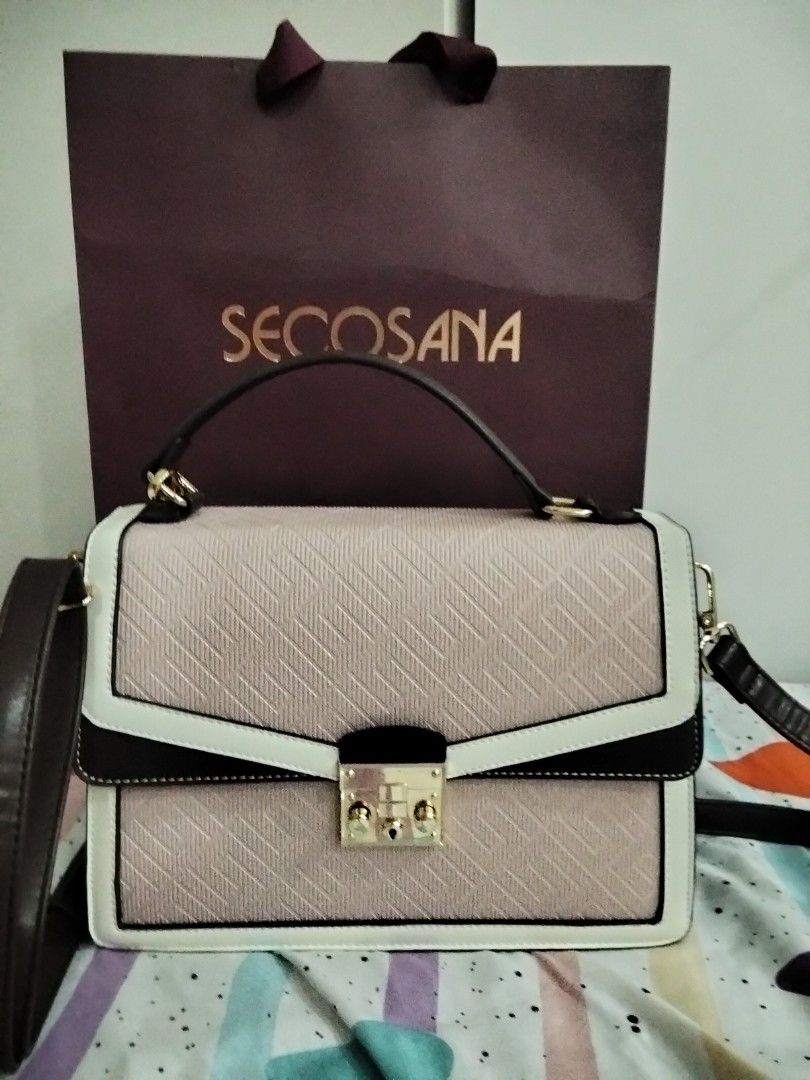Secosana Tri-Color Structured Handbag With Sling (Category: Tote Bags) located in Manila. Submitted by jeansuaco942346 (Listing ID 1467259352, Image 3). Description: - Brand: Secosana - Condition: Brand new / Never used (properly stored in closet) - Design: Tri-color structured handbag (Pink textured body with white and dark brown trim) - Hardware: Gold-tone with front lock closure - Features: Top handle and adjustable shoulder strap - Inclusions