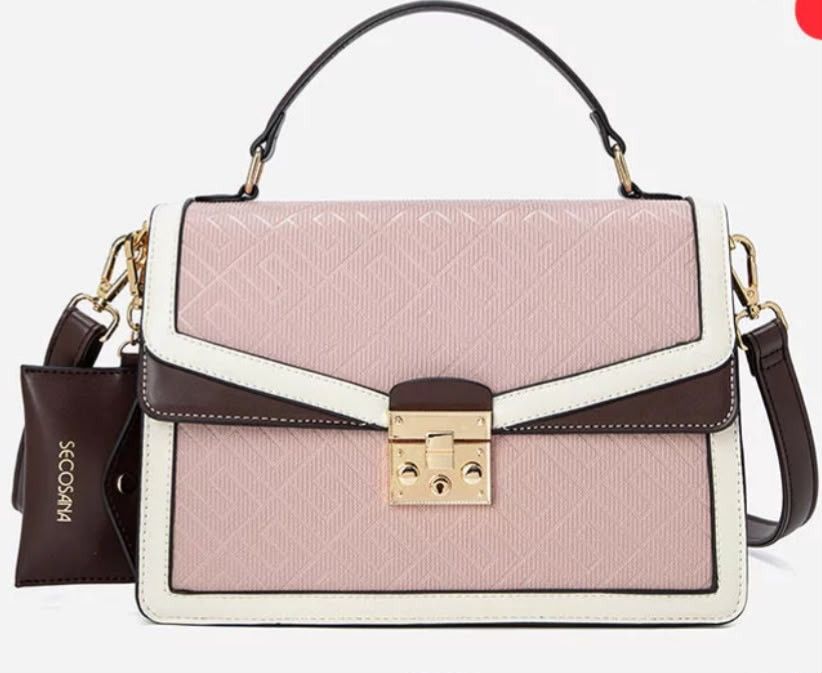 Secosana Tri-Color Structured Handbag With Sling (Category: Tote Bags) located in Manila. Submitted by jeansuaco942346 (Listing ID 1467259352, Image 1). Description: - Brand: Secosana - Condition: Brand new / Never used (properly stored in closet) - Design: Tri-color structured handbag (Pink textured body with white and dark brown trim) - Hardware: Gold-tone with front lock closure - Features: Top handle and adjustable shoulder strap - Inclusions