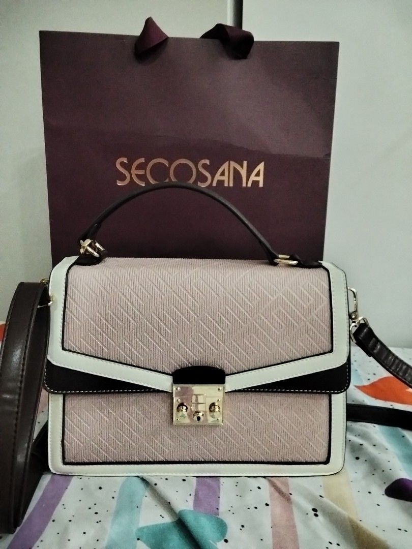Secosana Tri-Color Structured Handbag With Sling (Category: Tote Bags) located in Manila. Submitted by jeansuaco942346 (Listing ID 1467259352, Image 2). Description: - Brand: Secosana - Condition: Brand new / Never used (properly stored in closet) - Design: Tri-color structured handbag (Pink textured body with white and dark brown trim) - Hardware: Gold-tone with front lock closure - Features: Top handle and adjustable shoulder strap - Inclusions