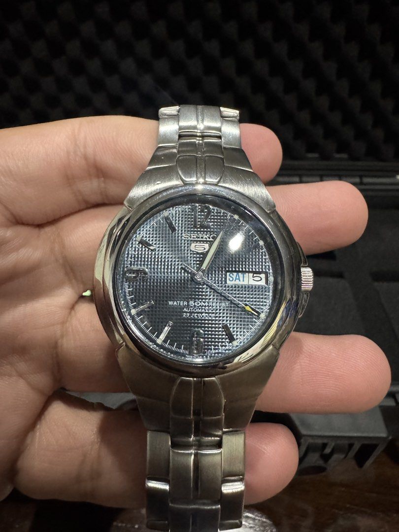 Seiko 5 Automatic “SNZB45” Blue Mosaic (Category: Men's Watches) located in Manila. Submitted by basilisk0816 (Listing ID 1467293514, Image 2). Description: - Textured black dial with silver numerals (6, 9, 12) - Convenient day and date window at 3 o'clock - Automatic movement with 23 jewels - 50 meters water resistance - Durable stainless steel bracelet with standard folding clasp - Cool exhibition case back showing the mechanical movement - Con