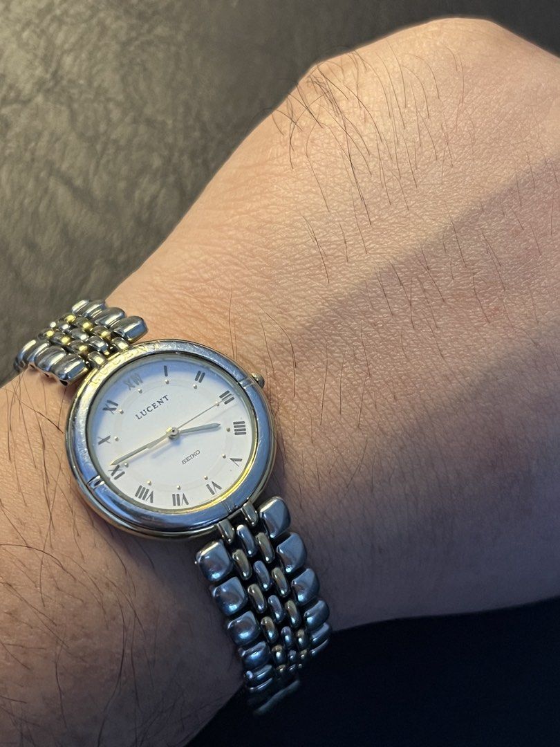 Seiko Lucent Two-Tone White Roman Dial Quartz – Ref. 7N01-6C60 (Category: Men's Watches) located in Quezon City. Submitted by bobby.brown. (Listing ID 1467174951, Image 3). Description: Seiko Lucent Two-Tone White Roman Dial Quartz – Ref. 7N01-6C60 Estimated BMBY: April 1991 A classic vintage dress watch from Seiko’s Lucent collection, featuring a round two-tone case accented with an engraved bezel and a crisp white dial. The dial showcases print