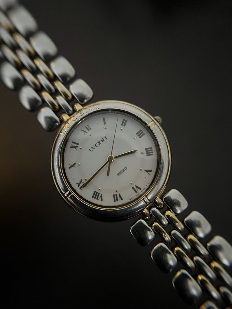 Seiko Lucent Two-Tone White Roman Dial Quartz – Ref. 7N01-6C60 (Category: Men's Watches) located in Quezon City. Submitted by bobby.brown. (Listing ID 1467174951, Image 1). Description: Seiko Lucent Two-Tone White Roman Dial Quartz – Ref. 7N01-6C60 Estimated BMBY: April 1991 A classic vintage dress watch from Seiko’s Lucent collection, featuring a round two-tone case accented with an engraved bezel and a crisp white dial. The dial showcases print