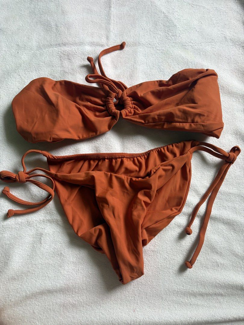 Sew Local PH Rust Orange Bikini Set (Category: Bikinis & Swimsuits) located in Makati City. Submitted by katch2 (Listing ID 1467315110, Image 1). Description: - Brand: Sew Local PH - Color: Rust Orange - Style: Bandeau top with center ring detail and neck tie, matching adjustable side-tie bottoms - Condition: Excellent, clean, no flaws - Ideal for: Beach trips, pool days, and summer getaways.