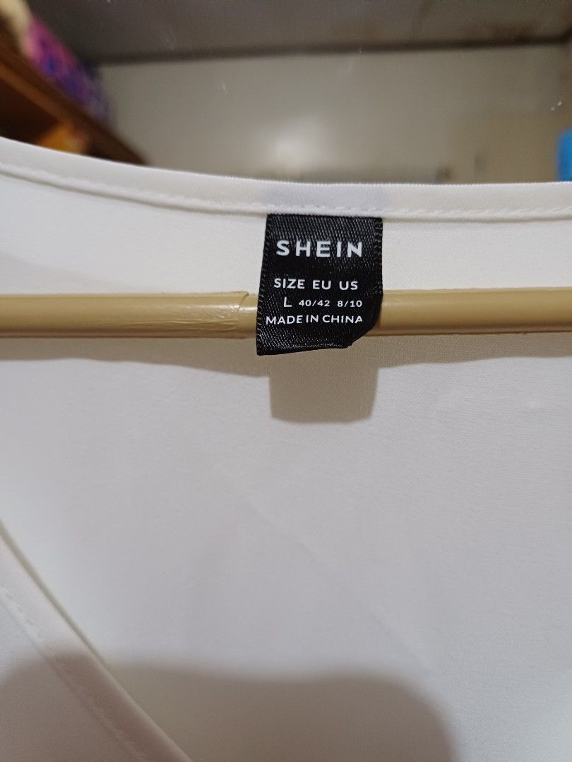 SHEIN White Pleated Dress Size L (Category: Dresses) located in San Pedro. Submitted by purpledream0316 (Listing ID 1467319313, Image 2). Description: - Brand: SHEIN - Style: White midi dress with V-neck and short sleeves - Features: Pleated skirt section and matching fabric waist tie - Size: L (EU 40/42, US 8/10) - Condition: Clean, solid white fabric, ready to wear.