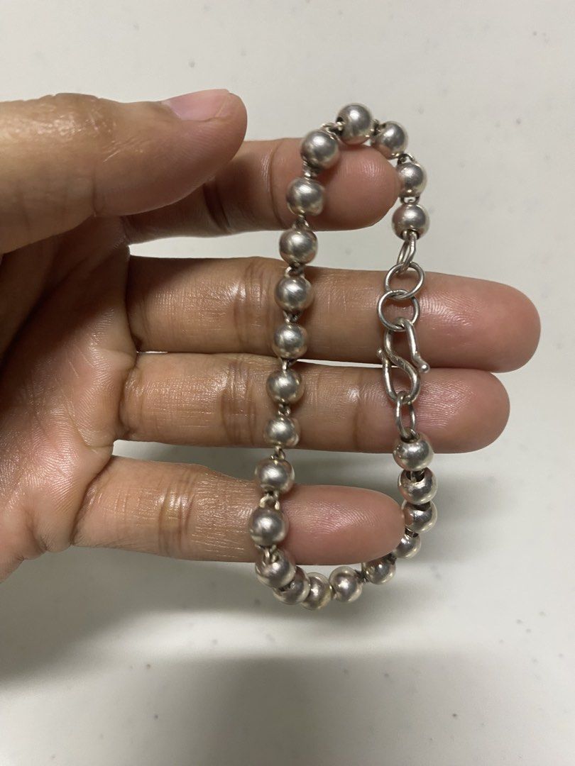 Silver Bead Chain Bracelet with S-Hook Clasp (Category: Bracelets) located in Pasacao. Submitted by wengpullar37205 (Listing ID 1467337531, Image 3). Description: - Silver bead bracelet with linked metallic spheres - Features adjustable S-hook clasp and extension rings - Versatile, simple design for daily wear - Condition: Minor signs of wear with slight surface scuffs on some beads -999 stamp/markings.