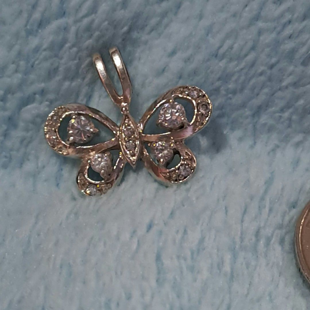Silver Butterfly Pendant with Crystal Stones (Category: Necklaces) located in Pila. Submitted by ester_aurea (Listing ID 1467212534, Image 2). Description: Vintage Silver Butterfly Pendant imported gcash+sf no cod - Design: Gorgeous butterfly shape with detailed openwork wings - Stones: Encrusted with clear crystal stones and larger round center stones - Backing: Solid metal backing for durability - Bail: Built-in bail that fits most standard cha
