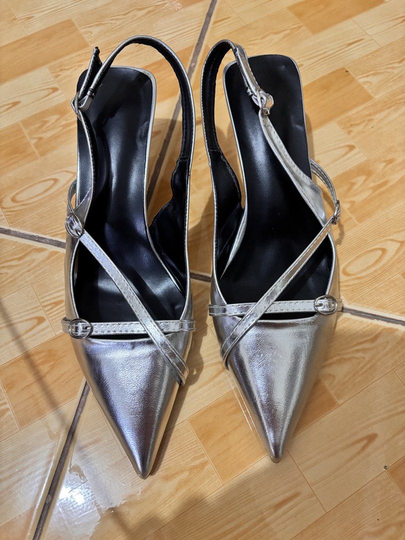 Silver Pointed Toe Slingback Kitten Heels With Buckle Straps (Category: Heels) located in Leyte. Submitted by modernpersephone (Listing ID 1467254828, Image 1). Description: - Color/Finish: Silver metallic - Design: Pointed toe with crisscross buckle straps - Heel: Thin flared heel (slight scuffing on soles from previous wear) - Fit: Adjustable buckle slingback strap - Interior: Black lining - Ideal for: Parties, dinners, or dressing up casual ou