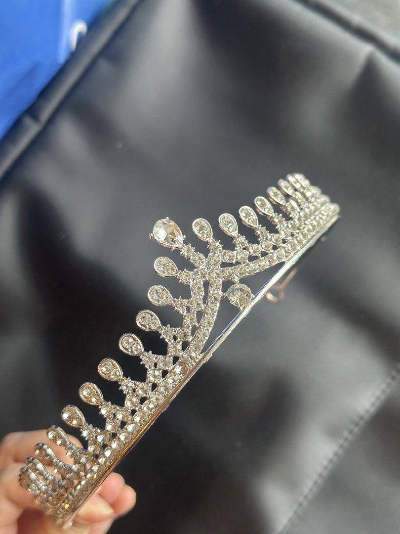 Silver Rhinestone Tiara Crown Hair Accessory (Category: Hair Accessories) located in Taguig. Submitted by ellajanee (Listing ID 1467233710, Image 2). Description: - Stunning silver rhinestone tiara with elegant teardrop crystal accents - Sturdy metal headband construction with sparkling stones embedded along the entire arch - Designed with convenient loop ends for secure pinning into hair - Ideal for weddings, proms, pageants, photo shoots, and c