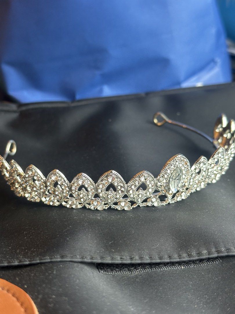 Silver Rhinestone Tiara Crown Hair Accessory (Category: Hair Accessories) located in Taguig. Submitted by ellajanee (Listing ID 1467234074, Image 2). Description: - Silver-tone metal headband with sparkling rhinestones and crystals - Elegant filigree leaf pattern band with a large marquise-cut center stone - Includes pin loops at each end for easy and secure pinning - Ideal accessory for weddings, proms, pageants, and costume parties - Condition: