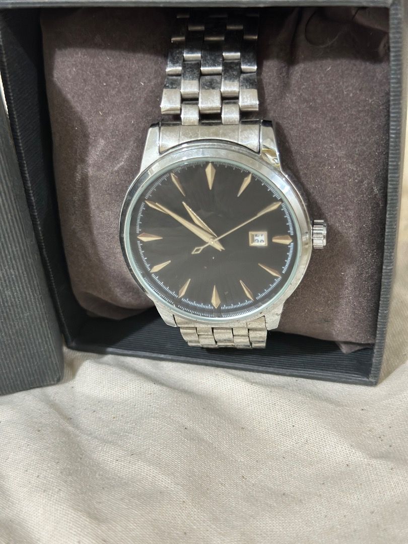 Silver wristwatch with black sunburst dial (Category: Men's Watches) located in Mandaluyong City. Submitted by lovedbyjaaaam (Listing ID 1467278002, Image 1). Description: - Stainless steel wristwatch with a polished silver-tone finish - Textured black sunburst dial with elegant gold-tone hands and hour markers - Convenient date window near the top of the dial - Multi-link metal bracelet with a secure deployant clasp - Clean crystal with minimal,