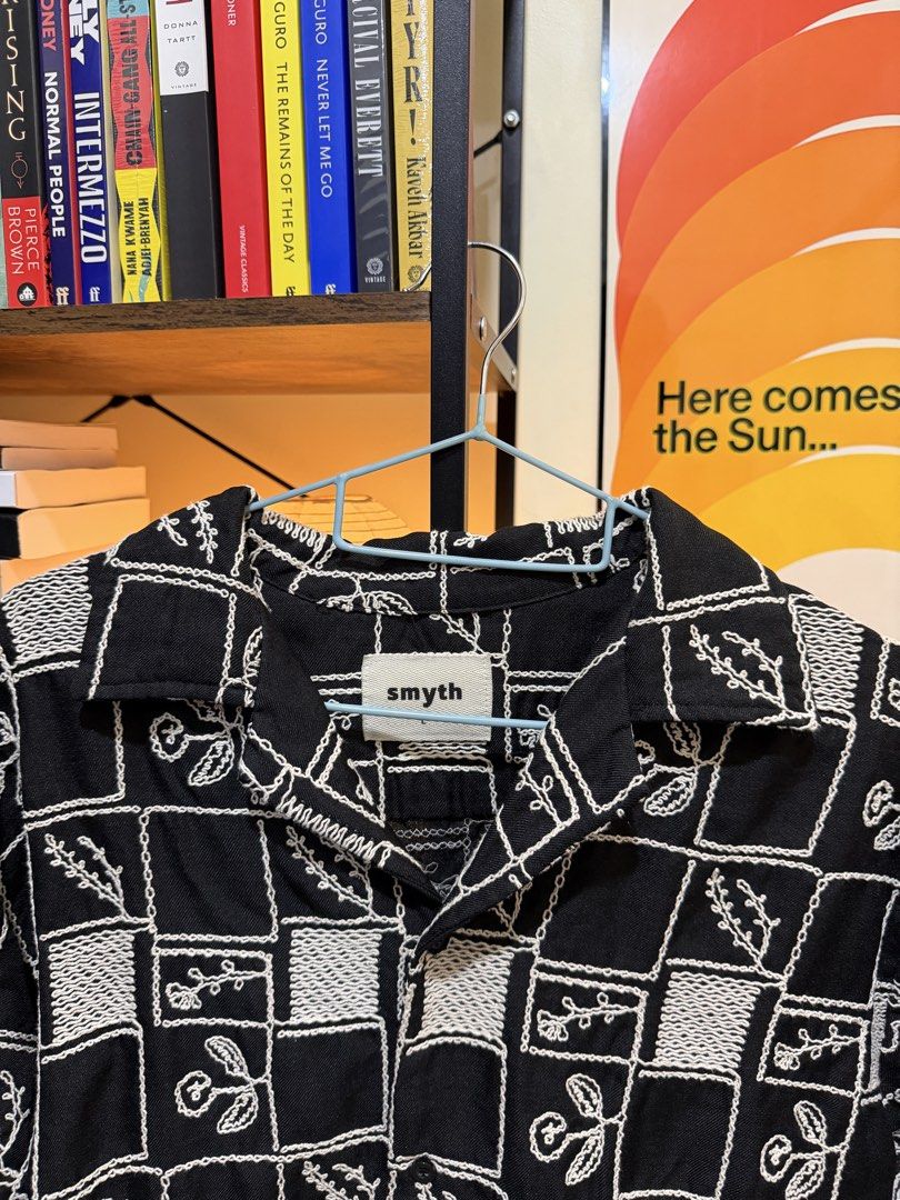 Smyth Black and White Patterned Short Sleeve Button Up Shirt (Category: Tshirts & Polo Shirts ) located in Makati City. Submitted by zonozon (Listing ID 1467299104, Image 2). Description: - Brand: Smyth - Color: Black and white - Style: Short-sleeve button-down with camp collar - Design: Textured checkerboard pattern with embroidered floral details inside squares - Condition: Clean and well-maintained - Versatility: Easy to style with denim or tr