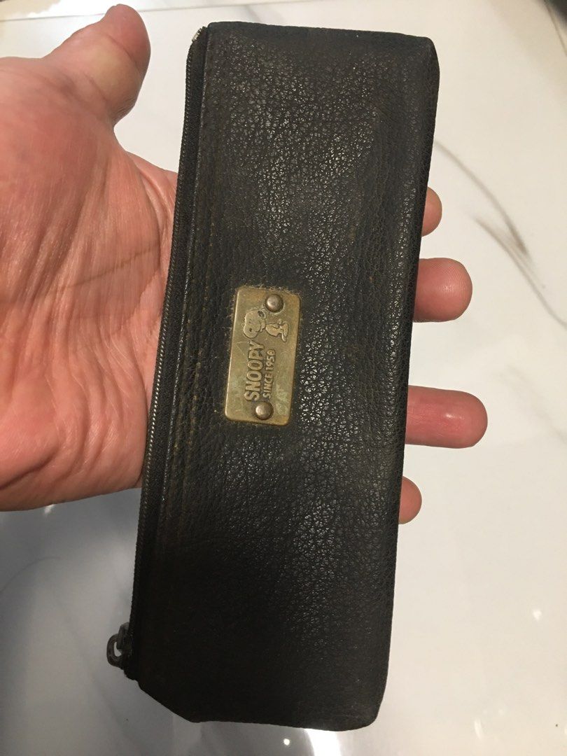 Snoopy Since 1950 Black Leather Pencil Case (Category: Purses & Pouches) located in Pasay City. Submitted by gilbertso62551 (Listing ID 1467275581, Image 2). Description: - Official Snoopy Since 1950 collection - Stylish black textured finish with gold-tone brand plaque and graphic - Secure zip closure featuring a metallic pull tab - Compact rectangular shape, perfect for daily use - Ideal for school, office, or gifting - As is, where is - Not Br