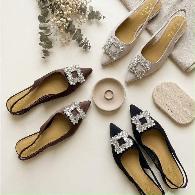 Solea Slingback Rhinestone Pointed Toe Flats (Category: Flats & Sandals) located in Paranaque City. Submitted by fourMs (Listing ID 1467225478, Image 1). Description: - Brand: Solea - Style: Pointed toe slingback flats - Color: Rich brown - Material: Satin with tan inner sole and branding - Feature: Large square crystal buckle on the front toe - Fit: Elastic heel strap for easy slip-on wear.