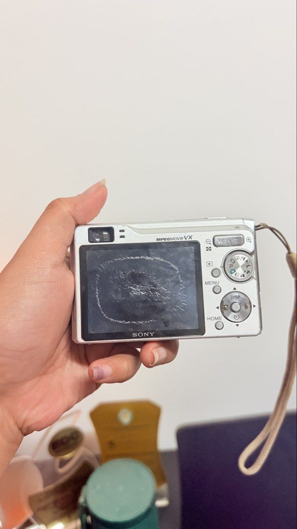 Sony Cyber-shot 7.2 Mega Pixels Digital Camera (Category: Cameras) located in Cebu City. Submitted by jnmryyy (Listing ID 1467314304, Image 2). Description: - Model: Silver Sony Cyber-shot Compact Digital Camera - Specs: 7.2 Mega Pixels, Carl Zeiss Vario-Tessar lens, and built-in flash - Condition: Body shows normal scuffs and wear from use; LCD screen has heavy scratches across the display - Inclusions: Original wrist strap attached - Note:Lost 