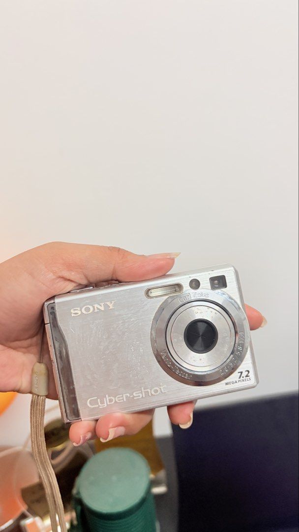 Sony Cyber-shot 7.2 Mega Pixels Digital Camera (Category: Cameras) located in Cebu City. Submitted by jnmryyy (Listing ID 1467314304, Image 1). Description: - Model: Silver Sony Cyber-shot Compact Digital Camera - Specs: 7.2 Mega Pixels, Carl Zeiss Vario-Tessar lens, and built-in flash - Condition: Body shows normal scuffs and wear from use; LCD screen has heavy scratches across the display - Inclusions: Original wrist strap attached - Note:Lost 