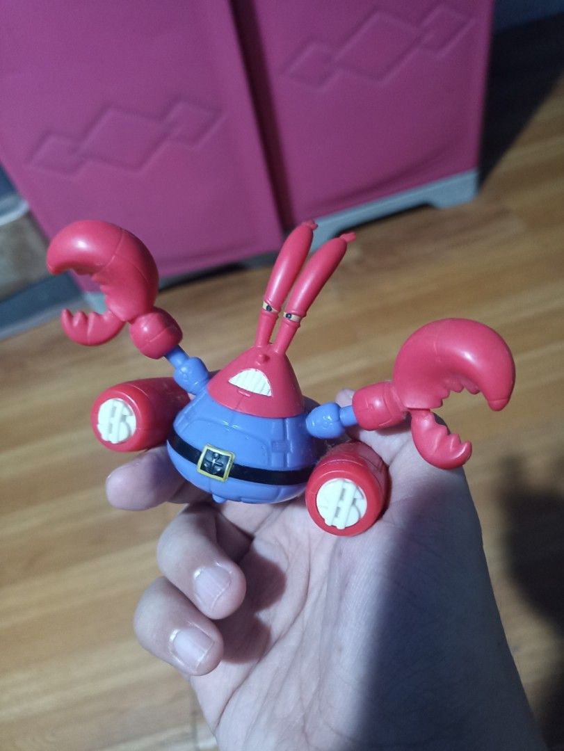 SpongeBob SquarePants Mr. Krabs Action Figure Toy (Category: Figurines & Statues) located in Manila. Submitted by hobbymo_koleksyon.ph (Listing ID 1467315438, Image 1). Description: - Character: Mr. Krabs from SpongeBob SquarePants - Outfit: Blue uniform with a black belt and yellow dollar sign buckle - Features: Dual mechanical crab claws and side rocket boosters with yellow flame details - Articulation: Movable arms and joints for posing - Cond