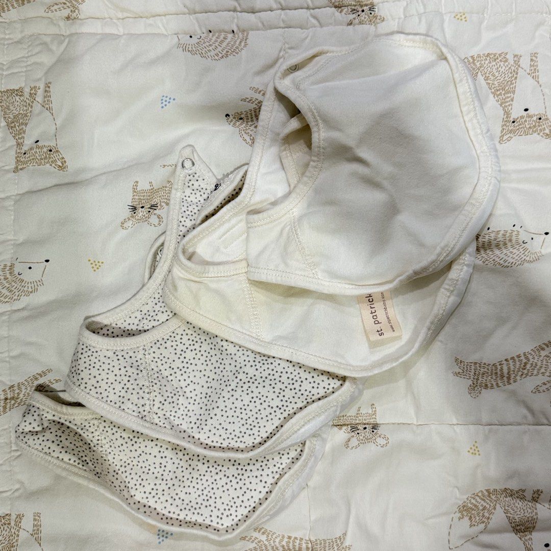 St Patrick Baby Bibs Set (Category: Babies & Kids Fashion) located in Paranaque City. Submitted by yuffie__ (Listing ID 1467188106, Image 1). Description: - Brand: St Patrick - Design: Plain cream and grey polka dot - Material: Soft, baby-friendly cotton - Closure: Easy snap button at the neck - Condition: Washed and ready for use - Ideal for: Feeding and drooling babies - Issue: with washable stains .