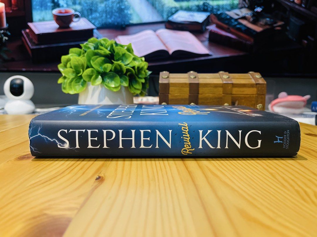 Stephen King Revival Hardcover Novel (Category: Storybooks) located in Makati City. Submitted by pagesandplay (Listing ID 1467319246, Image 2). Description: - Title: Revival by Stephen King - Format: Hardcover edition by Hodder & Stoughton - Cover Design: Dark blue with striking lightning and tent illustration - Condition: Spine, pages, and edges are clean and fully intact - Genre: Perfect for horror and suspense fiction lovers.
