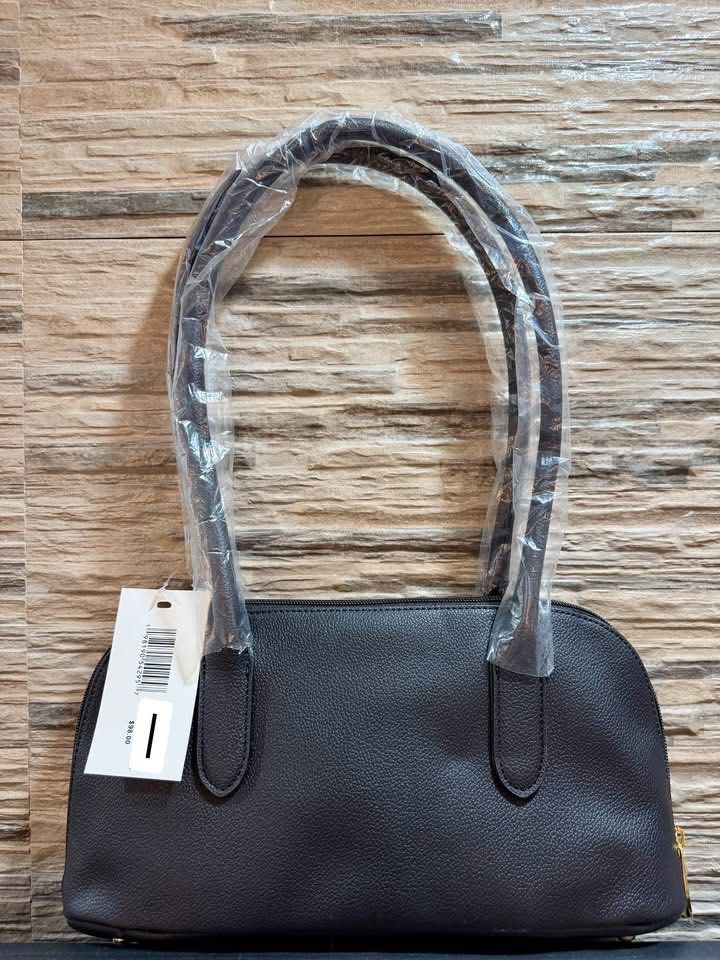 Steve Madden Black Shoulder Bag (Category: Shoulder Bags) located in Manila. Submitted by renee_12 (Listing ID 1467317340, Image 2). Description: - Brand: Steve Madden - Color: Classic Black - Material: Textured leather with a sleek, structured shape - Handles: Dual top handles, still wrapped in original protective plastic - Closure: Secure top zip closure - Details: Chic embossed logo on the front - Condition: Brand new with original retail tag 