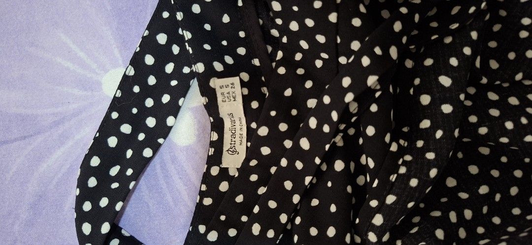 Stradivarius Black White Polka Dot Wrap Skirt (Category: Skirts) located in Taguig. Submitted by an.garcia (Listing ID 1467188649, Image 2). Description: - Brand: Stradivarius - Style: Wrap skirt with waist ties - Color/Pattern: Black with white polka dots - Size: S (EUR S, USA S, MEX 26) - Material: Lightweight fabric, made in China - Condition: Excellent - Versatile piece, easy to dress up or down for any occasion.