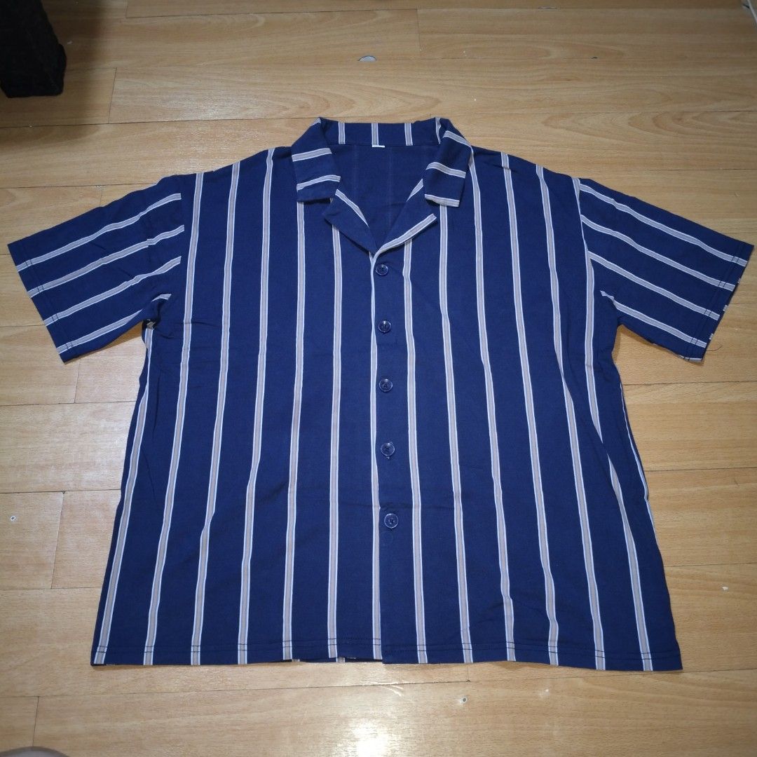 STRIPED BUTTON UP POLO (Category: Tshirts & Polo Shirts ) located in Manila. Submitted by friperie. (Listing ID 1467281696, Image 2). Description: Blue Striped Button-Up Polo – 95% Cotton, 5% Spandex 💙 Classic style with everyday comfort! Upgrade your everyday look with this stylish blue button-up polo featuring elegant vertical stripes in light flesh color. Designed with a classic open collar, short sleeves, and a full button-down front, it off
