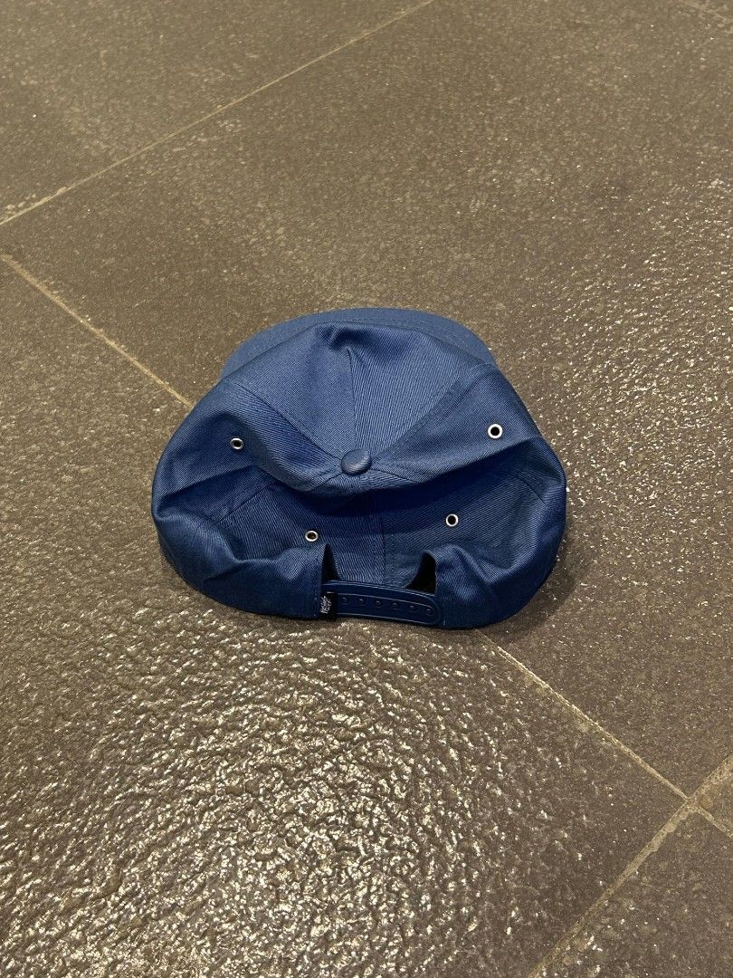 Stussy blue snapback cap with 8 ball logo (Category: Caps & Hats) located in Pasig City. Submitted by paulclzdo (Listing ID 1467208217, Image 2). Description: - Brand: Stussy - Design: Blue snapback cap with embroidered 8 ball logo on front - Brim: Classic flat brim - Closure: Adjustable snapback at the back - Details: Metal ventilation eyelets, interior taped seams, and branded woven tag - Condition: Clean structure with vibrant embroidery.
