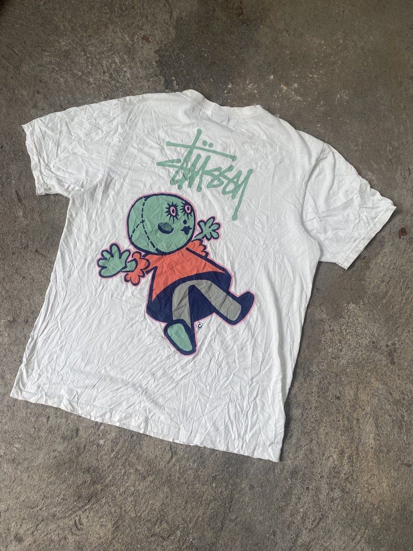 Stussy Graphic Tee White Size M (Category: Tshirts & Polo Shirts ) located in General Santos City (Dadiangas). Submitted by killcloa2368358 (Listing ID 1467340183, Image 2). Description: - Brand: Stussy - Color: White - Size: Medium - Material: 100% Cotton (Made in Guatemala) - Fit: Standard short sleeve crewneck - Design: Small left-chest logo and large alien doll back graphic with signature branding - Condition: Includes original neck tag and c