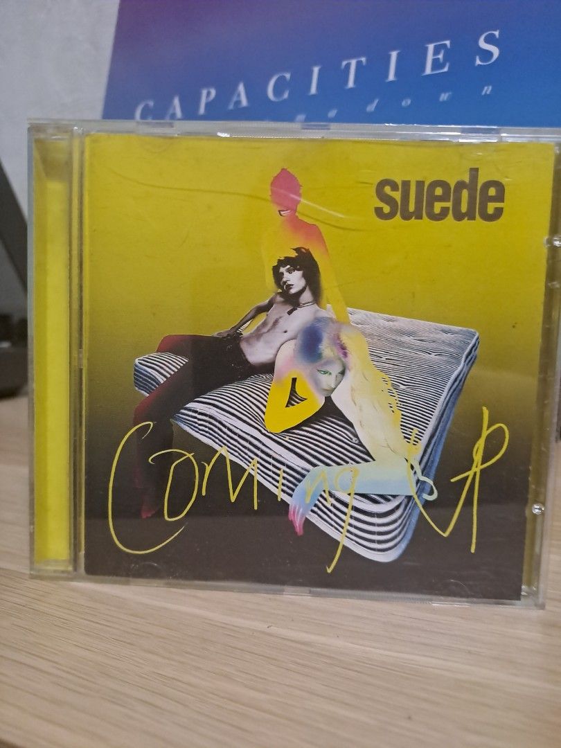 Suede Coming Up CD Album (Category: CDs & DVDs) located in Las Pinas. Submitted by cobieshop (Listing ID 1467320930, Image 1). Description: - Item: Suede 'Coming Up' Music Album (Compact Disc) - Packaging: Standard jewel case with iconic yellow and black artwork - Genre: Classic 90s Britpop and alternative rock - Condition: Minor wear on the case from storage, disc plays great - Perfect for: 90s music collectors and alternative rock fans - Shippi