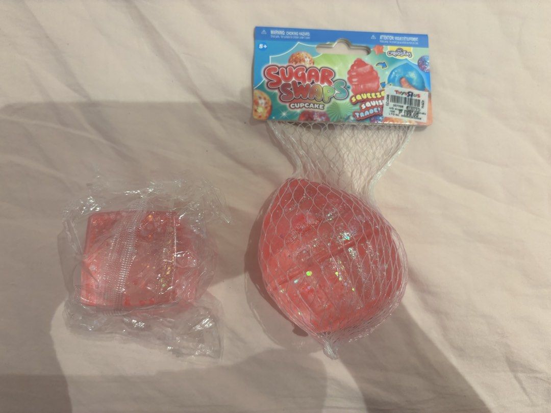 Sugar Swaps Cupcake Squeeze Toy (Category: Kids Toys) located in Quezon City. Submitted by kindakristelle2481 (Listing ID 1467199774, Image 1). Description: - Item: Sugar Swaps Cupcake Squishy Toy - Source: Authentic Toys R Us item - Condition: Brand new, unopened in original mesh net and plastic packaging - Features: Fun pink sparkly texture inside - Ideal for: Kids sensory play or toy collectors .