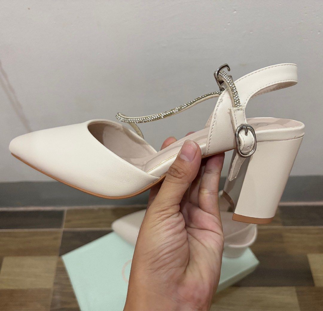 SUKI Cream pointed toe heels with rhinestone strap (Category: Heels) located in Los Banos. Submitted by _bugsssbunny (Listing ID 1467177364, Image 3). Description: - Brand: SUKI - Color: Cream - Style: Pointed toe with chunky block heel - Detail: Rhinestone-embellished ankle strap - Condition: Clean insoles and outsoles. Never been used, but may show minimal signs of storage. - Inclusion: Original box included.