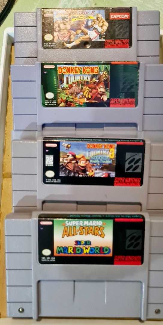 Super Nintendo and Super Famicom Games (Category: Nintendo) located in Manila. Submitted by cats_and_dogs_charity (Listing ID 1467311701, Image 1). Description: - Massive bundle of SNES and Super Famicom game cartridges - Includes iconic titles: Chrono Trigger, Final Fantasy V & VI, Ogre Battle, Romancing SaGa series, Donkey Kong Country, Street Fighter II Turbo, and Super Mario World - Mixed Japanese (Super Famicom) and US (SNES) versions - Idea