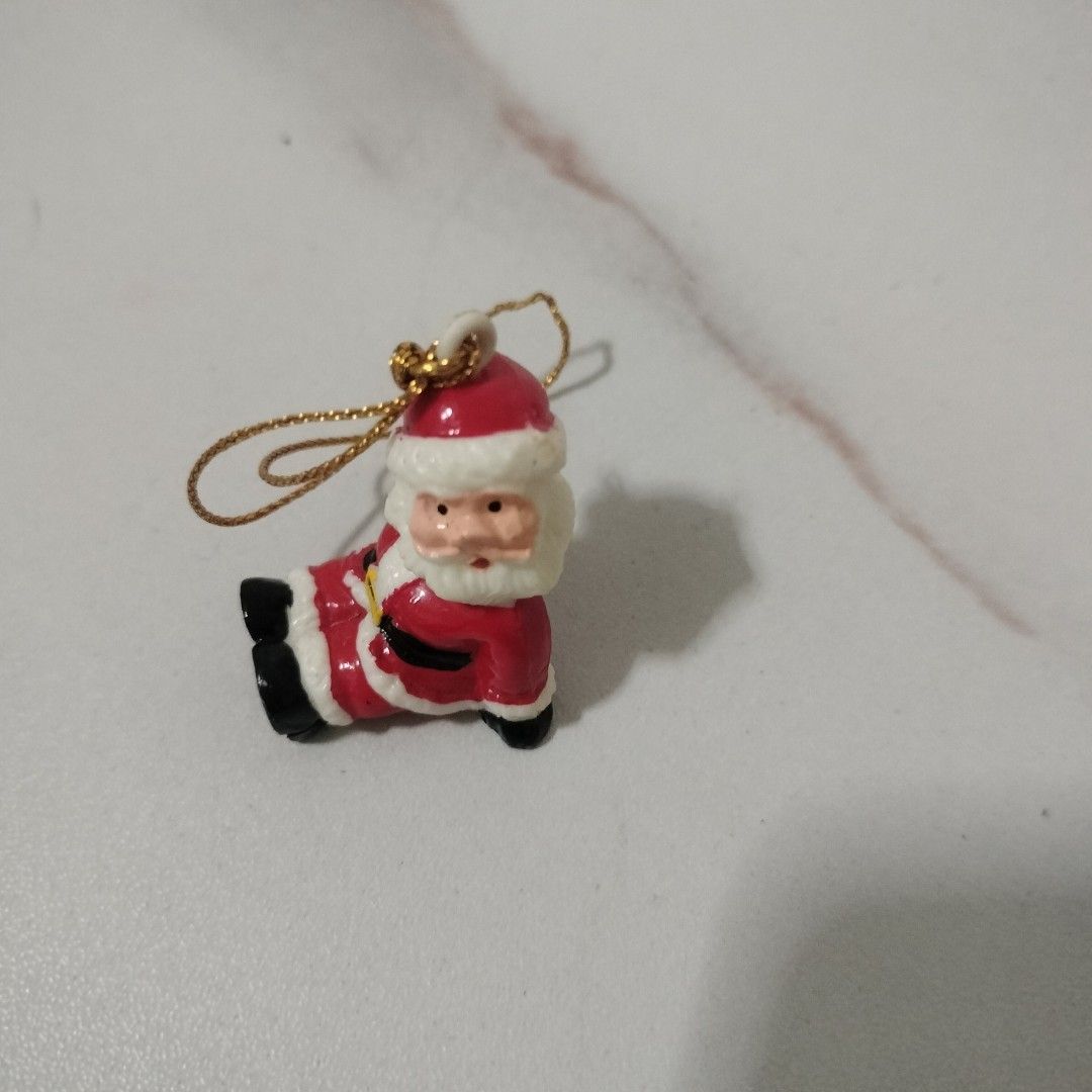 Take all Assorted mini Christmas tree hanging ornaments (Category: Figurines & Statues) located in Angeles City. Submitted by hellokittysanta (Listing ID 1467360640, Image 1). Description: - Set of cute miniature holiday hanging decorations - Includes Santa figures, Coca-Cola vending machine with seal, wooden penguin with lyre, and reindeer with a present - Comes with attached gold and red strings for easy tree hanging - Adds a festive and charmi