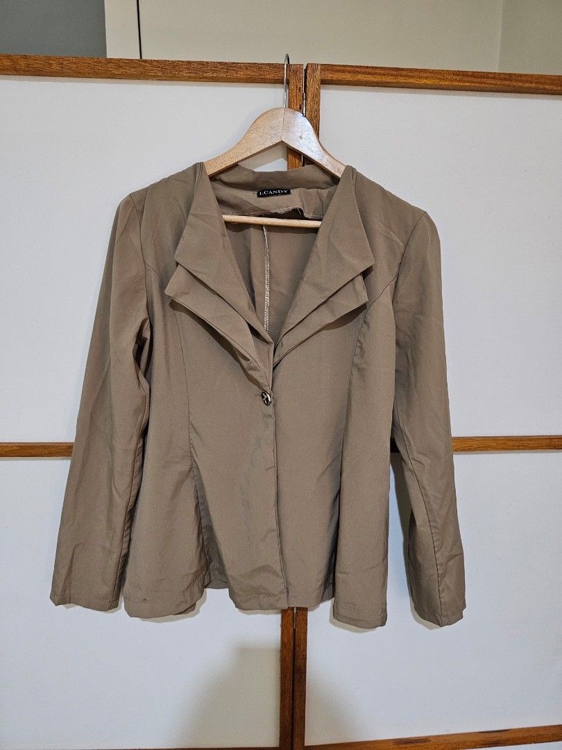 Taupe Long Sleeve Blazer Jacket (Category: Coats, Jackets and Outerwear) located in Quezon City. Submitted by moanascloset (Listing ID 1467351802, Image 2). Description: - Brand: I.Candy - Color: Taupe - Style: Long sleeves, structured collar, standard fit - Detail: One decorative center button with a small bow design - Fabric: Lightweight, ideal for layering over tops and dresses - Condition: Excellent.