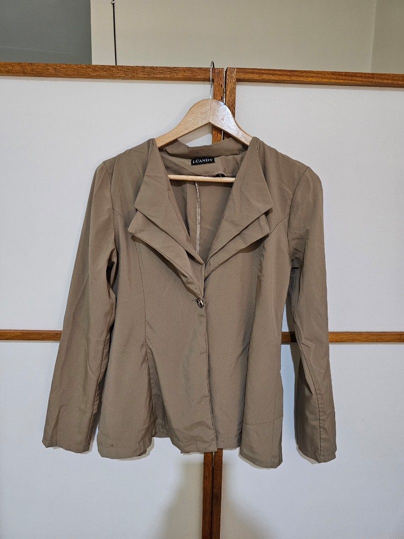 Taupe Long Sleeve Blazer Jacket (Category: Coats, Jackets and Outerwear) located in Quezon City. Submitted by moanascloset (Listing ID 1467351802, Image 1). Description: - Brand: I.Candy - Color: Taupe - Style: Long sleeves, structured collar, standard fit - Detail: One decorative center button with a small bow design - Fabric: Lightweight, ideal for layering over tops and dresses - Condition: Excellent.