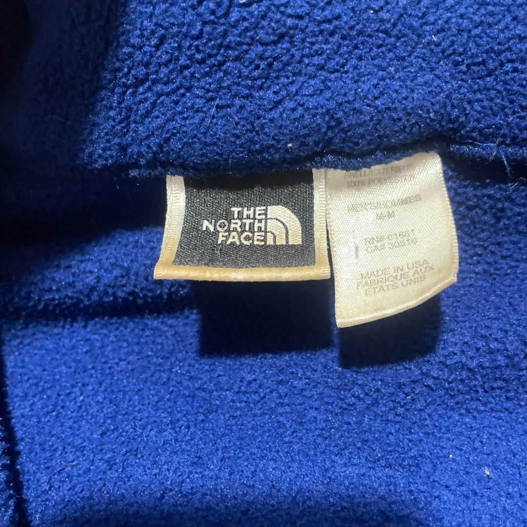 The North Face Blue Fleece Pullover Jacket (Category: Coats, Jackets and Outerwear) located in Taguig. Submitted by actualizeboutique (Listing ID 1467323841, Image 3). Description: - Brand: The North Face - Color: Deep Blue with Light Blue embroidered logo - Size: Men's Medium (Regular fit) - Material: 100% Polyester (Warm & soft) - Origin: Made in USA - Features: Half-zip collar with branded metal pull, two zippered hand pockets - Condition: Gre