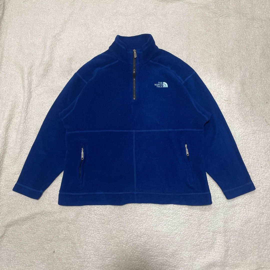 The North Face Blue Fleece Pullover Jacket (Category: Coats, Jackets and Outerwear) located in Taguig. Submitted by actualizeboutique (Listing ID 1467323841, Image 1). Description: - Brand: The North Face - Color: Deep Blue with Light Blue embroidered logo - Size: Men's Medium (Regular fit) - Material: 100% Polyester (Warm & soft) - Origin: Made in USA - Features: Half-zip collar with branded metal pull, two zippered hand pockets - Condition: Gre