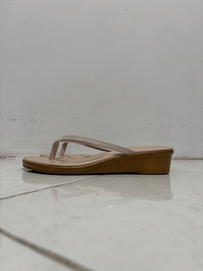 Thong Wedge Sandals (Category: Flats & Sandals) located in Manila. Submitted by safefire.ae92b7 (Listing ID 1467310513, Image 3). Description: - Color: Neutral beige with a contrasting light brown sole - Style: Simple slip-on thong sandals with thin straps and a low heel - Size: 7 - Good condition used twice .