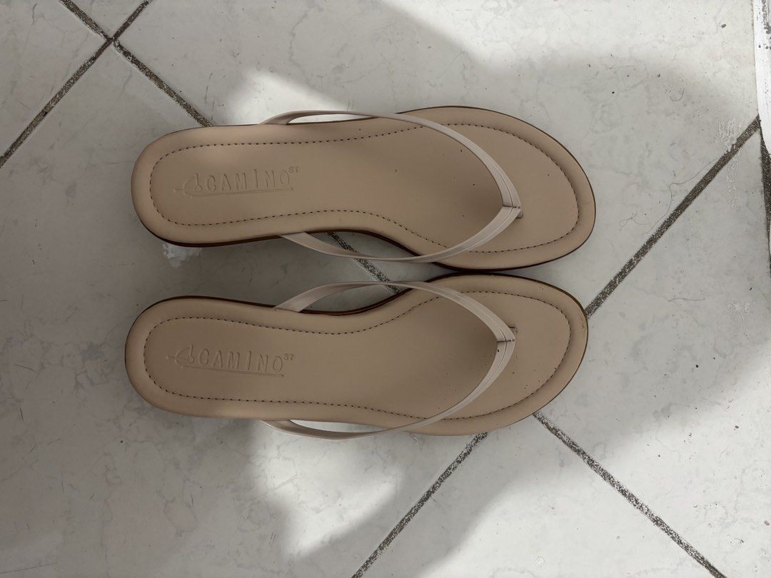 Thong Wedge Sandals (Category: Flats & Sandals) located in Manila. Submitted by safefire.ae92b7 (Listing ID 1467310513, Image 1). Description: - Color: Neutral beige with a contrasting light brown sole - Style: Simple slip-on thong sandals with thin straps and a low heel - Size: 7 - Good condition used twice .
