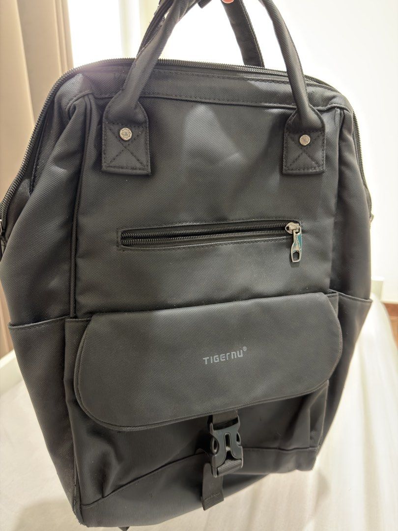 Tigernu Black Casual Backpack (Category: Backpacks) located in Makati City. Submitted by thisisshy (Listing ID 1467233528, Image 3). Description: - Authentic Tigernu backpack in sleek black, made from durable and sturdy material - Ideal everyday bag for school, work, or daily commute - Features top carrying handles and comfortable adjustable shoulder straps - Secure front flap pocket with buckle closure plus an extra zipped compartment - Wide-ope