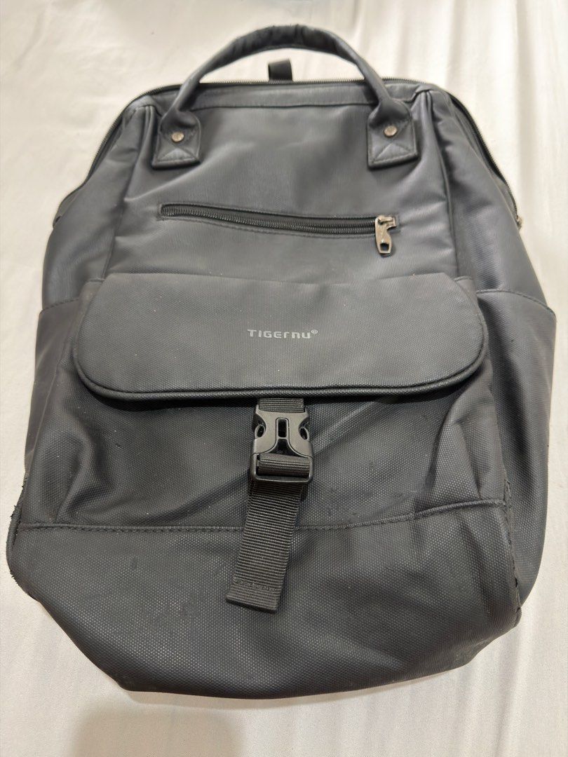 Tigernu Black Casual Backpack (Category: Backpacks) located in Makati City. Submitted by thisisshy (Listing ID 1467233528, Image 1). Description: - Authentic Tigernu backpack in sleek black, made from durable and sturdy material - Ideal everyday bag for school, work, or daily commute - Features top carrying handles and comfortable adjustable shoulder straps - Secure front flap pocket with buckle closure plus an extra zipped compartment - Wide-ope