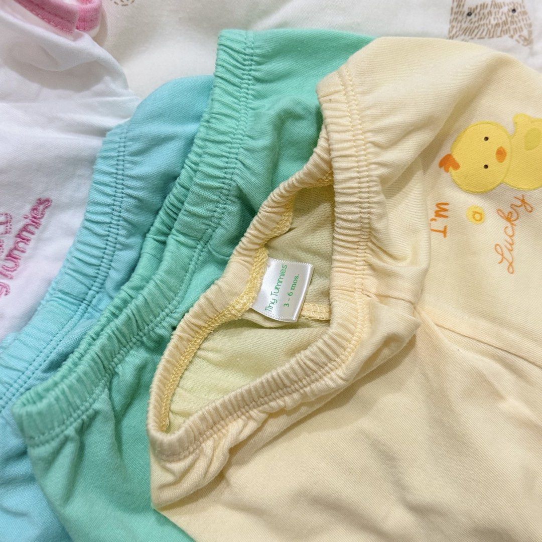 Tiny Tummies Baby Clothing Set 3-6 Months (Category: Babies & Kids Fashion) located in Paranaque City. Submitted by yuffie__ (Listing ID 1467194710, Image 2). Description: - Brand: Tiny Tummies - Size: 3-6 months - Material: Soft cotton with gentle wash instructions - Includes: White side-tie short-sleeve tops with pink trim - Includes: Matching mint green pants - Includes: Yellow pants with a cute 'I'm Lucky' duck graphic.