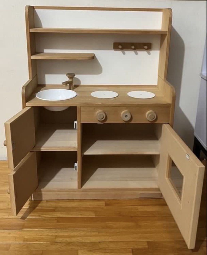Tipp Tapp Wooden Toy Kitchen Play Set (Category: Kids Toys) located in Taytay. Submitted by y71054 (Listing ID 1467351549, Image 2). Description: - Brand: Tipp Tapp Wooden Play Kitchen - Design: Natural wood finish with chic white cabinet doors - Features: White sink basin, 2 stovetop burners, and working turning dials - Storage: Underneath cabinets, built-in hanging hooks, and an upper shelf - Perfect for toddler role-play and Montessori-inspire