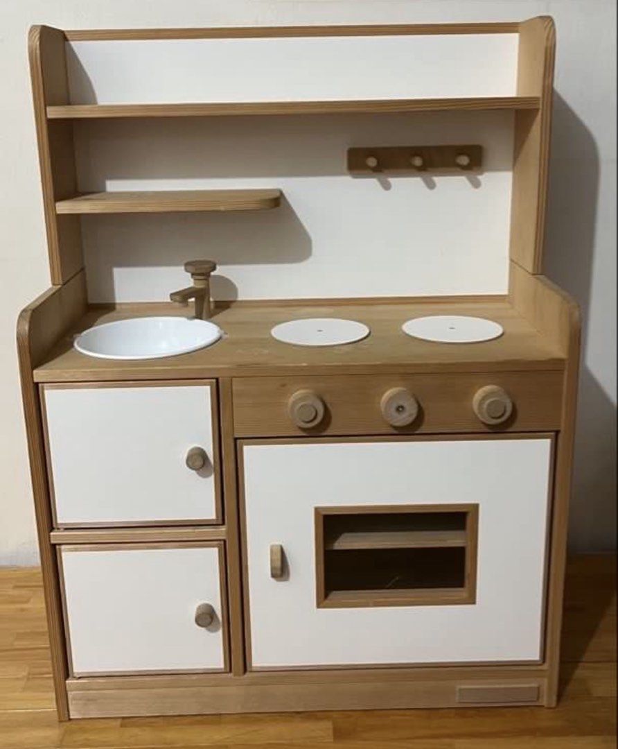 Tipp Tapp Wooden Toy Kitchen Play Set (Category: Kids Toys) located in Taytay. Submitted by y71054 (Listing ID 1467351549, Image 1). Description: - Brand: Tipp Tapp Wooden Play Kitchen - Design: Natural wood finish with chic white cabinet doors - Features: White sink basin, 2 stovetop burners, and working turning dials - Storage: Underneath cabinets, built-in hanging hooks, and an upper shelf - Perfect for toddler role-play and Montessori-inspire