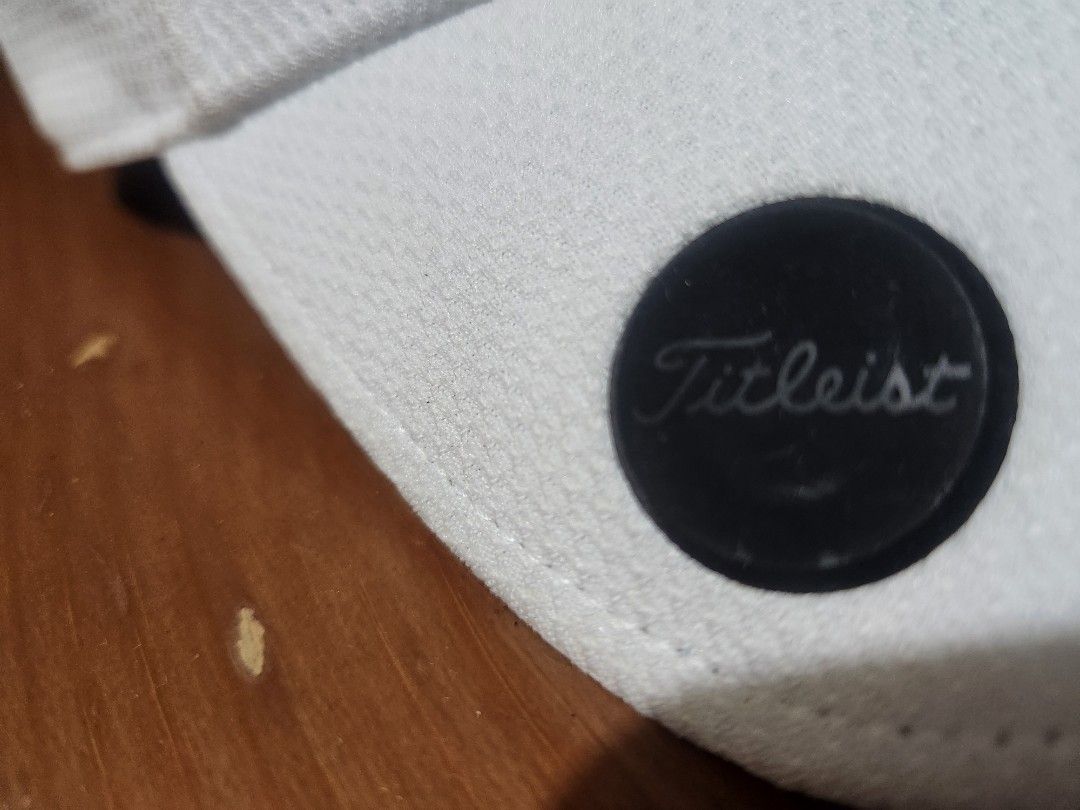 Titleist White Golf Cap Hat (Category: Caps & Hats) located in Quezon City. Submitted by amber___18 (Listing ID 1467314913, Image 3). Description: - Authentic Titleist golf cap in classic white - Black embroidered logo lettering on front and back - Breathable mesh material construction - Structured fit with interior branded taping.