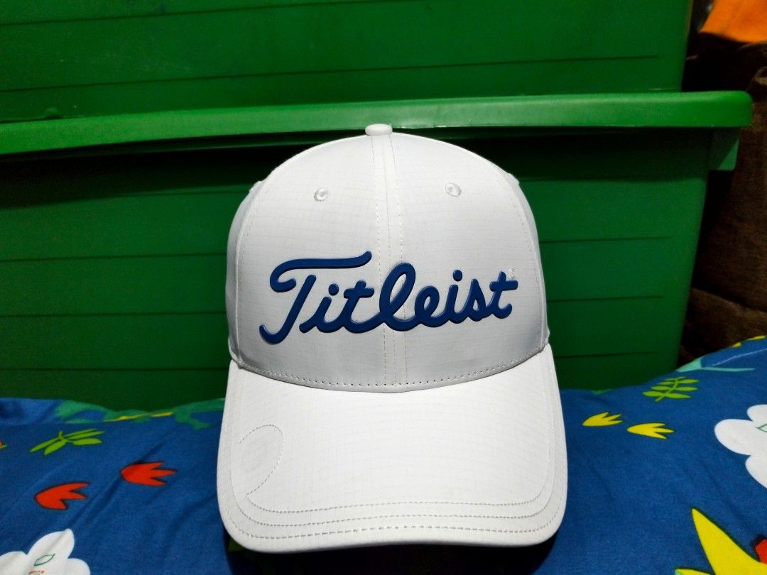 Titleist White Golf Cap Hat With Blue Script Logo (Category: Caps & Hats) located in San Mateo. Submitted by JmThriftCap_Ph (Listing ID 1467317249, Image 1). Description: - Authentic Titleist golf cap in crisp white - Eye-catching bold blue raised script logo on the front - Durable ripstop grid fabric construction - Adjustable strapback closure with small Titleist branding tab - Interior taped seams branded with Titleist text - Structured crown a