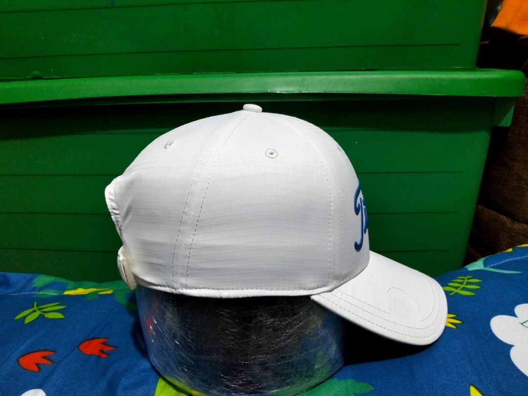Titleist White Golf Cap Hat With Blue Script Logo (Category: Caps & Hats) located in San Mateo. Submitted by JmThriftCap_Ph (Listing ID 1467317249, Image 2). Description: - Authentic Titleist golf cap in crisp white - Eye-catching bold blue raised script logo on the front - Durable ripstop grid fabric construction - Adjustable strapback closure with small Titleist branding tab - Interior taped seams branded with Titleist text - Structured crown a
