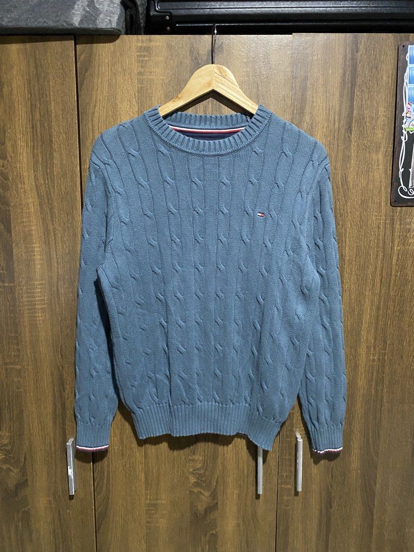 Tommy Hilfiger Cable Knit Sweater Blue (Category: Coats, Jackets and Outerwear) located in Antipolo. Submitted by cogiestamaria (Listing ID 1467195576, Image 1). Description: - Brand: Tommy Hilfiger - Size: Small - dimes W19-L24.5 - no issue - color rate 10-10 - good as new - Style: Cable knit crewneck with signature red, white, and blue stripe ribbed cuffs and hem - Logo: Iconic embroidered flag on the chest - Material: Soft and comfortable knit