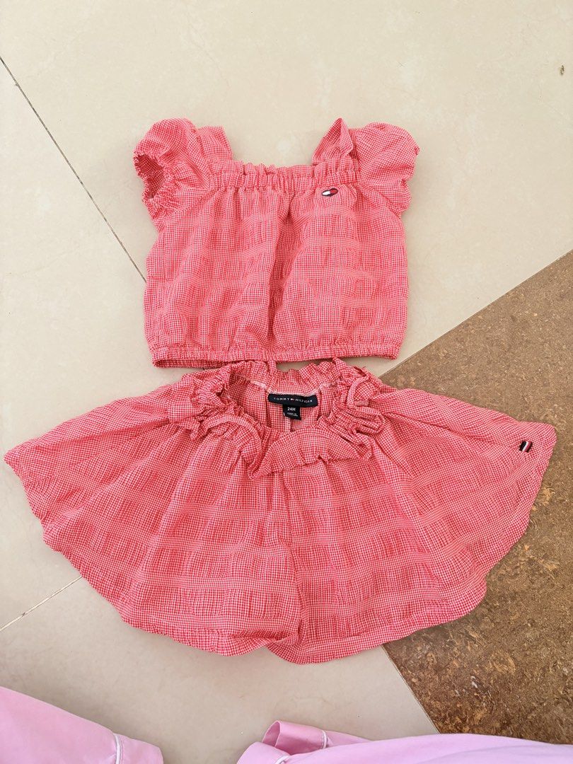 Tommy Hilfiger Red Gingham Top and Skort Set 24M (Category: Babies & Kids Fashion) located in Tarlac. Submitted by therusticaddict (Listing ID 1467191078, Image 1). Description: - Brand: Tommy Hilfiger - Style: Red and white gingham two-piece set (crop top & skort) - Size: 24M (Made in Thailand) - Details: Smocked neckline, embroidered flag logo, elastic waistband, and ruffled trim - Material: Lightweight and comfortable fabric for toddlers -GOOD