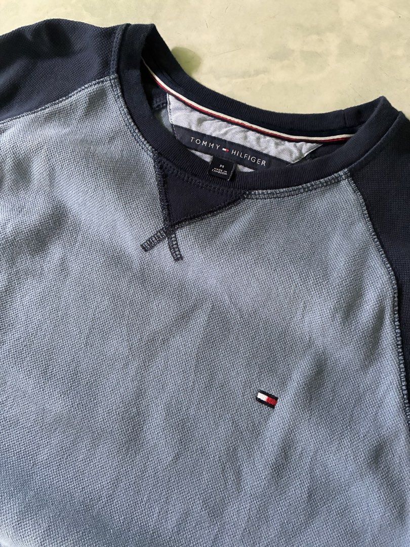 Tommy Hilfiger Two-Tone Raglan Sweatshirt (Category: Coats, Jackets and Outerwear) located in Batangas. Submitted by jinventoryarchive (Listing ID 1467230420, Image 3). Description: 21x27 - Brand: Tommy Hilfiger - Style: Crewneck sweatshirt with raglan sleeves - Color: Navy blue and light blue contrast - Size: Medium - Details: Thermal waffle knit chest/back panels, embroidered flag logo on chest, contrast ribbed cuffs, collar, and hem - Material